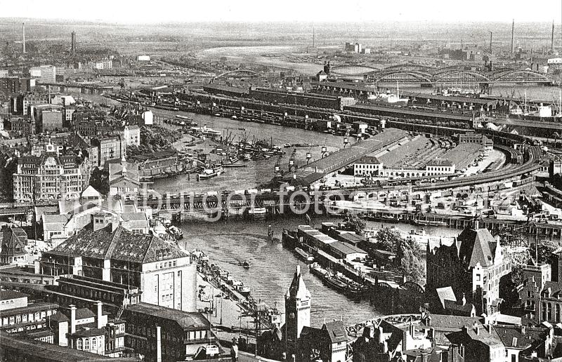 0226_76_73003 Blick ber den Oberhafen und den Oberhafenkanal - im Vordergrund der Portalturm der Wandrahmsbrcke. In der Bildmitte die Oberhafenbrcke und der Gterbahnhof, dahinter die Kaischuppen am Versmannkai des Baakenhafens sowie die Elbbrcken ber die Norderelbe. Links ist die Eisenbahnbrcke ber den Billehafen zu erkennen.