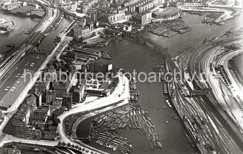 0249_237_87_1 Blick ber den Oberhafenkanal und den Billehafen - in der oberen linken Bildmitte die Brandshofer Schleuse, die zu den Hammberbrooker Kanlen fhrt. Im Vordergrund ist ein Ausschnitt der Hammbrooker Schleuse zu erkennen. Rechts die Gleisanlagen mit Gterwaggons auf dem Gterbahnhof; eine Eisenbahnbrcke fhrt ber den Kanal. Schuten und Arbeitsschiffe liegen eng beieinander auf dem Wasser.