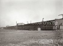 620_641a Blick zur Landseite des Verteilungsschuppen 60 - Gterwaggons stehen an der Laderampe des Hafenschuppens. In einer kleinen Bretterbude mit Schornstein ist der Pfrtner der Kaiverwaltung untergebracht, ein Schild unter dem Dach weist darauf hin. Hinter dem Gebudes ragen die Ausleger der Kaikrane empor - ganz links ist der Kirchturm der St. Nikolai kirche zu erkennen.