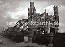 784_142 Portal der 1899 fertig gestellten Straenelbbrcke ber die Norderelbe zwischen der Veddel und Hamburg Rothenburgsort - am anderen Ufer sind Wohngebude des Stadtteils zu erkennen. Eine Straenbahn mit der Aufschrift "Freihafen" passiert gerade das imposanten Portal der Norderelbbrcke.