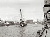 02234_750a Der Schwimmkran hat den verunglckten Rollkran an Deck gehievt und fhrt mit eigenem Antrieb durch den Baakenhafen Richtung Elbe. Im Hintergrund das Gasometer und die Schornsteine der Hamburger Gasanstalt auf dem Groen Grasbrook.